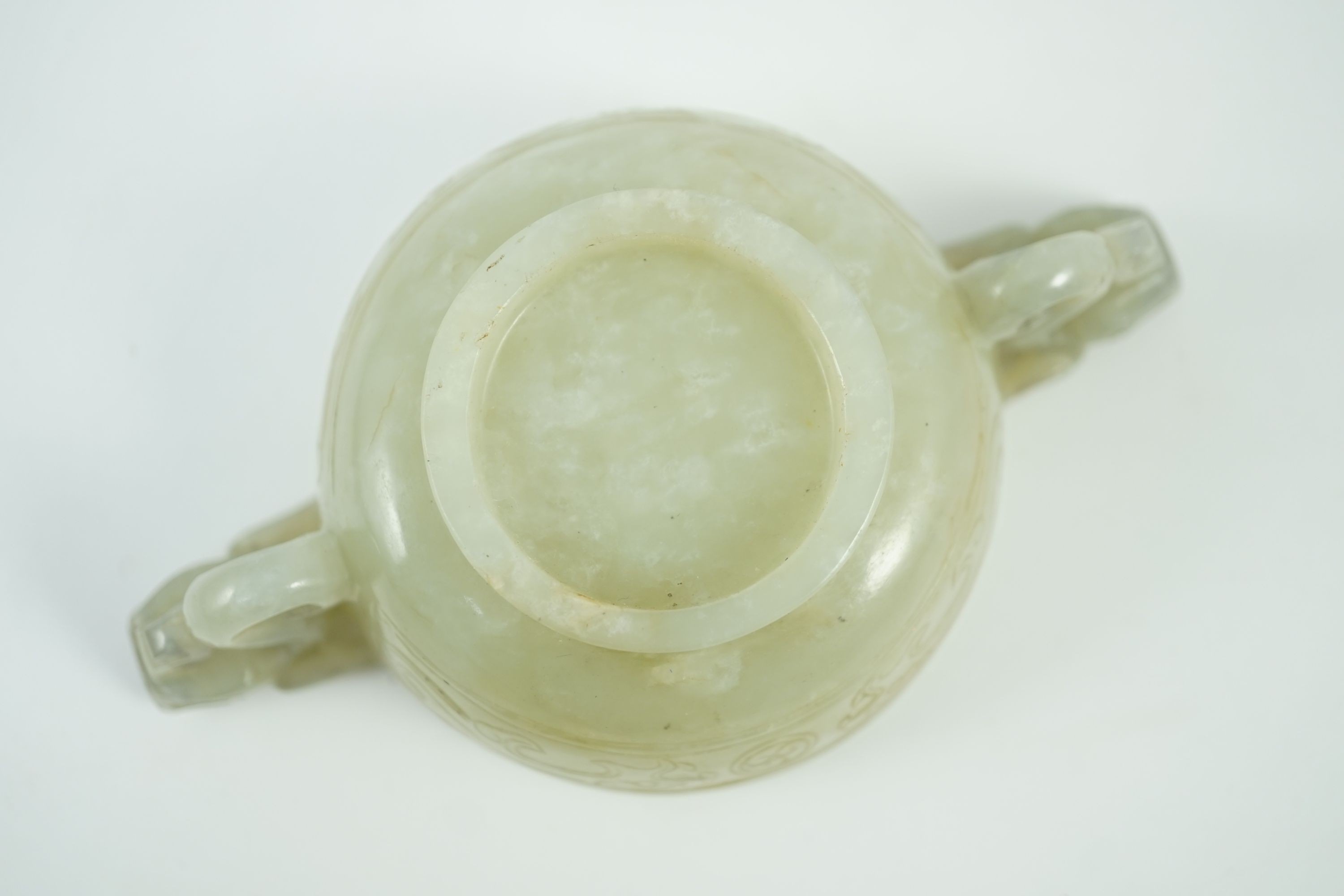 A Chinese pale celadon jade two handled ‘chilong’ cup, 17th/18th century, 13.2cm wide